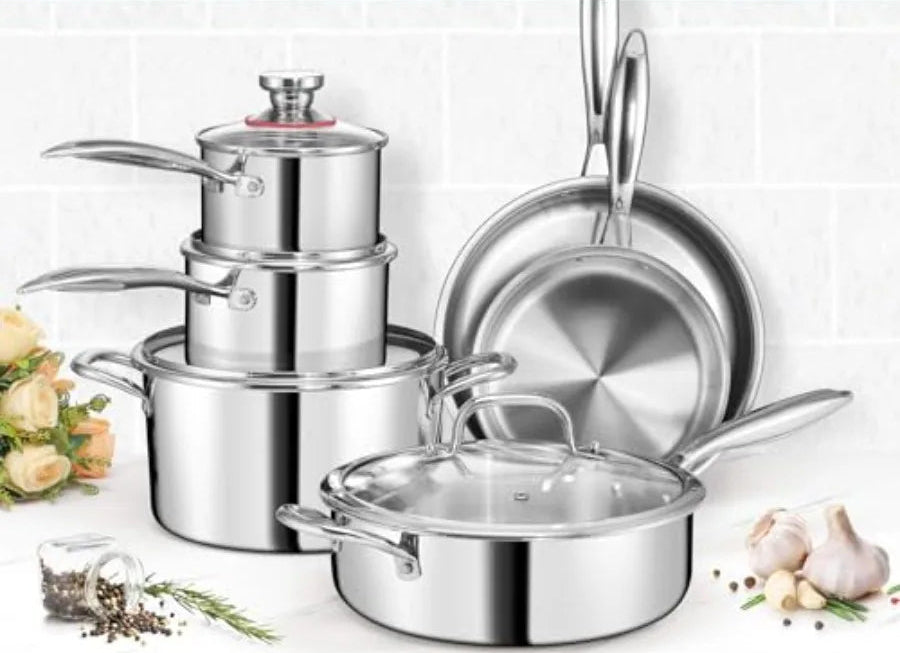 Set of stainless steel cookware with pots, pans, and lids on a white background.