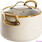 Beige cookware with gold handles and lid on a white background